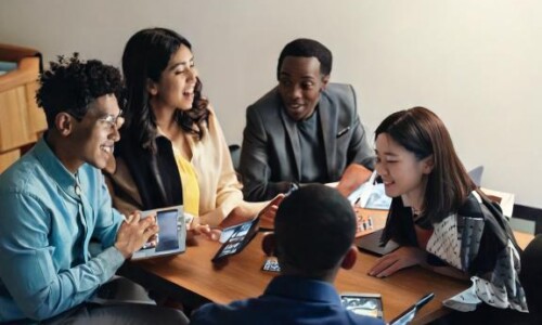 A diverse group of people watching an engaging video on various devices
